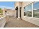 Front porch with brick pavers and a view of the front door and windows of the home at 890 Spinnaker Way, Kissimmee, FL 34746