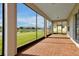 Wide-angle view of a screened lanai showing lake and neighborhood views at 890 Spinnaker Way, Kissimmee, FL 34746