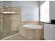 Beautiful bathroom features soaking tub and glass shower at 890 Spinnaker Way, Kissimmee, FL 34746