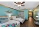 Bright bedroom with two beds, wood floor, and ceiling fan at 8900 Candy Palm Rd, Kissimmee, FL 34747