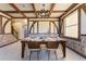 Dining room with exposed ceiling beams, wood paneled wall, and custom window at 8900 Candy Palm Rd, Kissimmee, FL 34747