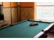 Game room features a pool table next to a window, and a tiki themed wall at 8900 Candy Palm Rd, Kissimmee, FL 34747