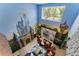 Unique living room featuring a whimsical castle mural and a cozy seating area with access to a patio at 8900 Candy Palm Rd, Kissimmee, FL 34747