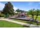 Community playground including slide with woodchip ground covering and nearby walkway at 8900 Candy Palm Rd, Kissimmee, FL 34747