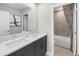 Bright bathroom featuring double sinks, quartz countertops, and a decorative shower curtain at 9280 Sea Pine Ave, Orlando, FL 32832