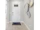 Inviting entryway features a white front door, decorative wall art, and a stylish welcome mat at 9280 Sea Pine Ave, Orlando, FL 32832