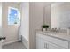 Bright bathroom with white vanity, tiled tub and bright window at 9292 Sea Pine Ave, Orlando, FL 32832