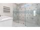 Modern bathroom featuring glass shower with decorative tile and marble floors and countertop at 9292 Sea Pine Ave, Orlando, FL 32832