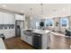 Modern kitchen with island seating, stainless steel appliances, and an open layout connecting to the dining area at 9292 Sea Pine Ave, Orlando, FL 32832