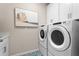 Laundry room with side-by-side washer and dryer and stylish tile floors at 9292 Sea Pine Ave, Orlando, FL 32832