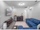 Cozy living room showcasing a blue sectional sofa and a modern entertainment system at 9918 Pallida Hickory Way, Winter Garden, FL 34787