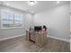 Office featuring neutral walls, wood floors, a window with shutters, and a wooden desk at 9918 Pallida Hickory Way, Winter Garden, FL 34787