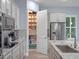 Well-stocked pantry with an organized shelving system and stainless steel refrigerator at 9918 Pallida Hickory Way, Winter Garden, FL 34787