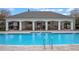 Community pool featuring zero entry, brick pavers, clubhouse, and lounge seating at 9918 Pallida Hickory Way, Winter Garden, FL 34787