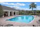 Community pool featuring brick pavers, lounge chairs, and clubhouse at 9918 Pallida Hickory Way, Winter Garden, FL 34787