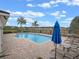 Community pool with brick pavers, lounge chairs, and sunny blue skies at 9918 Pallida Hickory Way, Winter Garden, FL 34787