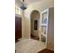 Inviting foyer features light tile floors, arched entryways, and a modern light fixture at 1011 Piedmont Oaks Dr, Apopka, FL 32703