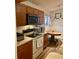 Bright kitchen with wood cabinets, modern appliances, a round wood table, and wood-look floors at 1011 Piedmont Oaks Dr, Apopka, FL 32703