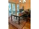 A well-lit room, a large wood table, a patterned area rug, and natural light from a sliding glass door at 1011 Piedmont Oaks Dr, Apopka, FL 32703