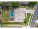 Aerial view of a home with a screened pool, well-manicured lawn, and mature landscaping at 105 Lena Ann Dr, St Cloud, FL 34771