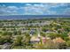 Picturesque aerial view of a neighborhood with a lake and beautiful homes, creating an inviting setting at 105 Lena Ann Dr, St Cloud, FL 34771