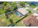 Aerial view of a home with a screened pool and a nicely landscaped yard at 105 Lena Ann Dr, St Cloud, FL 34771