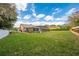 Spacious backyard with a screened pool and lush green lawn at 105 Lena Ann Dr, St Cloud, FL 34771