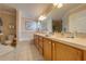 Well-lit bathroom features double vanity, tile floors, and a separate tub at 105 Lena Ann Dr, St Cloud, FL 34771