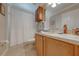 Bathroom featuring a toilet, sink, cabinet and shower with white curtain at 105 Lena Ann Dr, St Cloud, FL 34771
