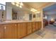 Bright bathroom with double vanity, wood cabinets and access to the main bedroom at 105 Lena Ann Dr, St Cloud, FL 34771