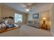 Bedroom features a ceiling fan, window and floral sofa at 105 Lena Ann Dr, St Cloud, FL 34771