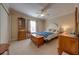 Bedroom features a bed, ceiling fan, and dresser at 105 Lena Ann Dr, St Cloud, FL 34771