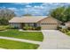 Charming single Gathering home with a well-manicured front lawn and a two-car garage at 105 Lena Ann Dr, St Cloud, FL 34771