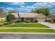 Inviting single-story home featuring a lush green lawn and mature landscaping in a sunny neighborhood at 105 Lena Ann Dr, St Cloud, FL 34771