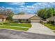 Traditional home boasting well-kept landscaping, a spacious driveway, and an attached two-car garage at 105 Lena Ann Dr, St Cloud, FL 34771