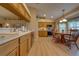Bright kitchen with wood cabinetry, laminate floors, and a cozy breakfast nook at 105 Lena Ann Dr, St Cloud, FL 34771