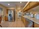 Bright kitchen featuring stainless steel appliances, light wood cabinets, and a view to the living room at 105 Lena Ann Dr, St Cloud, FL 34771