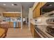 Open concept kitchen with stainless appliances, light wood cabinets, and views to the living areas at 105 Lena Ann Dr, St Cloud, FL 34771