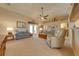 Living room with vaulted ceilings, comfortable seating and access to the outdoor patio at 105 Lena Ann Dr, St Cloud, FL 34771