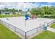 Aerial view of a fenced playground area with slides, swings, and play equipment at 105 Lena Ann Dr, St Cloud, FL 34771