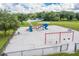 Overhead shot of a fenced playground area with slides, swings, and benches at 105 Lena Ann Dr, St Cloud, FL 34771