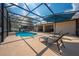 Screened-in pool area featuring comfortable lounge chairs and dining space at 105 Lena Ann Dr, St Cloud, FL 34771