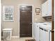 Functional laundry room with washer, dryer, window, and storage space at 11 Stone Gate S, Longwood, FL 32779