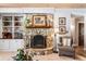 Living room showcasing a stone fireplace, built-in bookshelves, and cozy seating arrangement at 11 Stone Gate S, Longwood, FL 32779