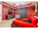 A cozy themed room with a red-painted walls, decorative banners and themed decor at 1507 Carey Palm Cir, Kissimmee, FL 34747