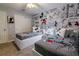 Charming bedroom features twin beds adorned with Mickey Mouse bedding and wallpaper with vintage comic strip design at 1507 Carey Palm Cir, Kissimmee, FL 34747