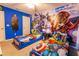 Marvel themed bedroom featuring twin beds with Captain America bedding and a large mural of the Avengers at 1507 Carey Palm Cir, Kissimmee, FL 34747