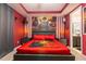 Themed bedroom featuring a large mural, red accent walls, and an ensuite bathroom at 1507 Carey Palm Cir, Kissimmee, FL 34747