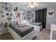 Charming bedroom features twin beds adorned with Mickey Mouse bedding and wallpaper with vintage comic strip design at 1507 Carey Palm Cir, Kissimmee, FL 34747