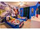 Marvel themed bedroom provides twin beds, a large mural of the Avengers, and lots of Super Hero themed decor at 1507 Carey Palm Cir, Kissimmee, FL 34747